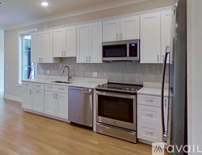 Boston apartment for rent - A kitchen with white cabinets and stainless steel appliances.