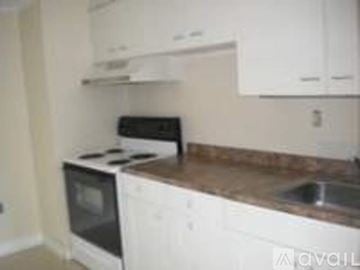 Wilton apartment for rent - A kitchen with white cabinets and a granite counter top.