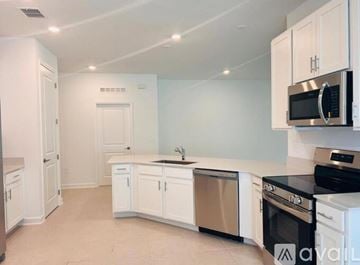 Davenport house for rent - A kitchen with white cabinets and appliances.