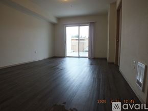 Seattle apartment for rent - A room with wooden flooring and a large window.