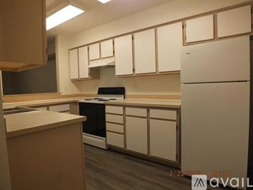 Seattle apartment for rent - A kitchen with white cabinets and a black dishwasher.