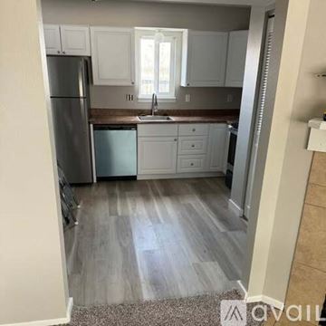 Colorado Springs townhouse for rent - A kitchen with white cabinets and a refrigerator.