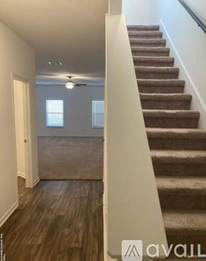 New Braunfels house for rent - A staircase with a carpeted runner and wooden steps leads up to a second floor.