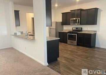 New Braunfels house for rent - A kitchen with dark wood cabinets and a white wall.
