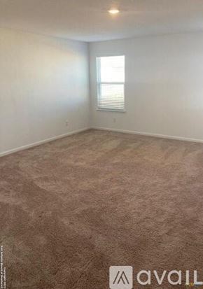New Braunfels house for rent - A room with a carpeted floor and a window with blinds.