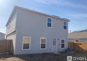 New Braunfels house for rent - A two-story house with a white exterior and a brown fence.