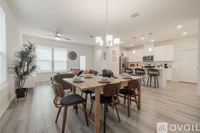 Bastrop house for rent - A modern dining room with a wooden table and chairs.