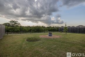 Bastrop house for rent - A park with a fence and a small tree in the middle of a grassy area.