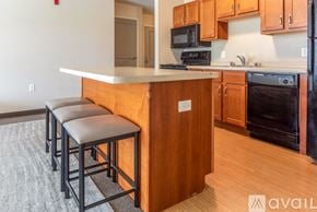 Whitewater apartment for rent - A kitchen with a white counter top and wooden cabinets.