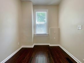 Louisville house for rent - A room with wooden floors and a window.