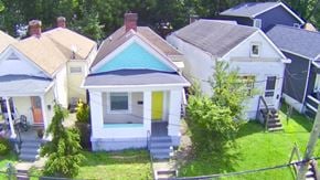 Louisville house for rent - A small house with a blue roof is in the middle of a cluster of houses.