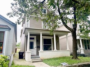 Louisville apartment for rent - A house with a front porch and a tree in front.