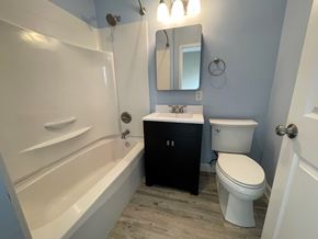 Louisville apartment for rent - A white toilet sits next to a sink in a bathroom.