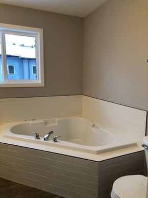 Fort Mcmurray house for rent - A bathroom with a white tub and a window.