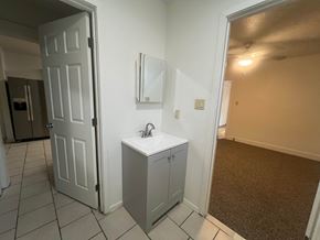 Stockton house for rent - A bathroom with a white sink and a white door.