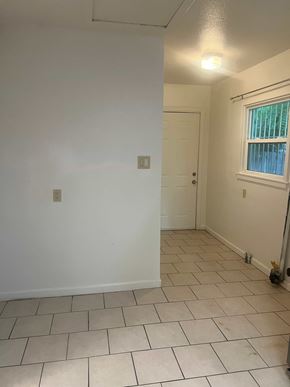 Stockton house for rent - A room with white walls and a tiled floor.