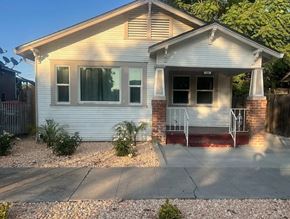 Stockton house for rent - A small house with a porch and a garage door.