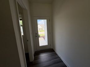 Wilson apartment for rent - A white door with a window on the side is open.