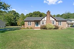 Jacksonville house for rent - A house with a brick chimney and a green lawn.