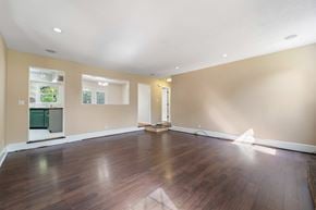 Jacksonville house for rent - A room with wooden floors and a white ceiling.