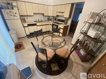 Cedar Lake apartment for rent - A kitchen with a table and chairs in the middle.