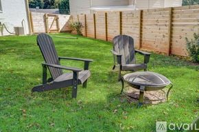 Hapeville house for rent - Two chairs and a table are placed on a grassy lawn.