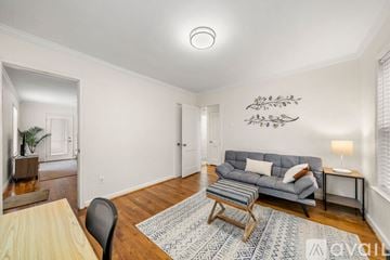 Hapeville house for rent - A living room with a grey couch and a wooden coffee table.