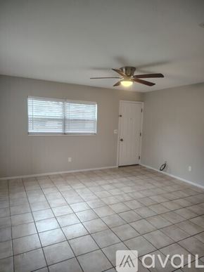 Tampa apartment for rent - A room with a ceiling fan and a window with blinds.