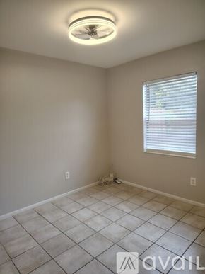 Tampa apartment for rent - A house with a brown door and windows surrounded by green grass.