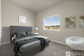 Summerset apartment for rent - A bedroom with a large bed and a window overlooking a desert landscape.