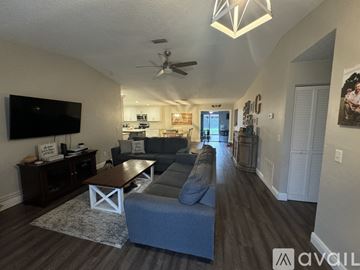 Palm Coast house for rent - A living room with a grey couch and a wooden coffee table.
