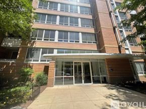 Washington condo for rent - A building with a glass entrance and a brick facade.