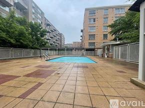 Washington condo for rent - A pool surrounded by a tiled patio in a residential area.