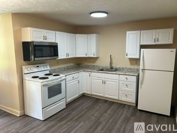 Bemus Point apartment for rent - A kitchen with white appliances and cabinets.