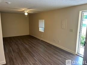 Bemus Point apartment for rent - A room with wooden flooring and a window with blinds.