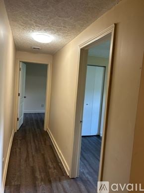 Bemus Point apartment for rent - A hallway with wooden floors and white walls.