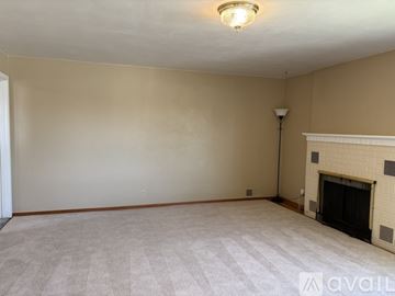 Sunnyside house for rent - A kitchen with wooden cabinets and a white refrigerator.