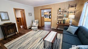 Corinth house for rent - A living room with a dark blue couch and a striped rug.