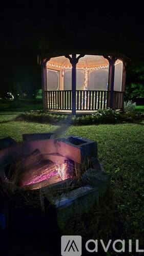 Corinth house for rent - A gazebo is lit up at night with string lights.