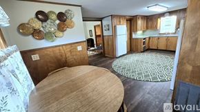 Corinth house for rent - A kitchen with a wooden table and a wall hanging of coins.