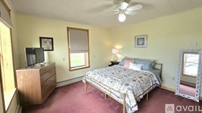Corinth house for rent - A bedroom with a bed, dresser, and window.