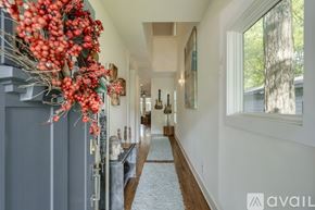 Nashville house for rent - A hallway with a decorative garland on the left side and a carpeted floor.