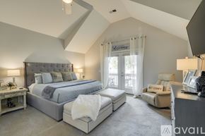 Nashville house for rent - A bedroom with a large bed and a chair is available for rent.