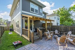 Nashville house for rent - A house with a grey exterior and a wooden deck with chairs.