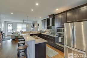 Nashville house for rent - A modern kitchen with dark wood cabinets and stainless steel appliances.