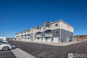 Summerset apartment for rent - A row of modern townhouses with a car parked in front.