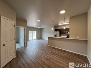 Summerset apartment for rent - A spacious room with wooden flooring and a kitchen area in the background.