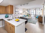 Washington apartment for rent - A kitchen with a white counter top and wooden cabinets.