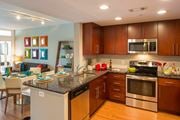 Washington apartment for rent - A modern kitchen with wooden cabinets and stainless steel appliances.