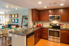 Washington apartment for rent - A modern kitchen with wooden cabinets and stainless steel appliances.